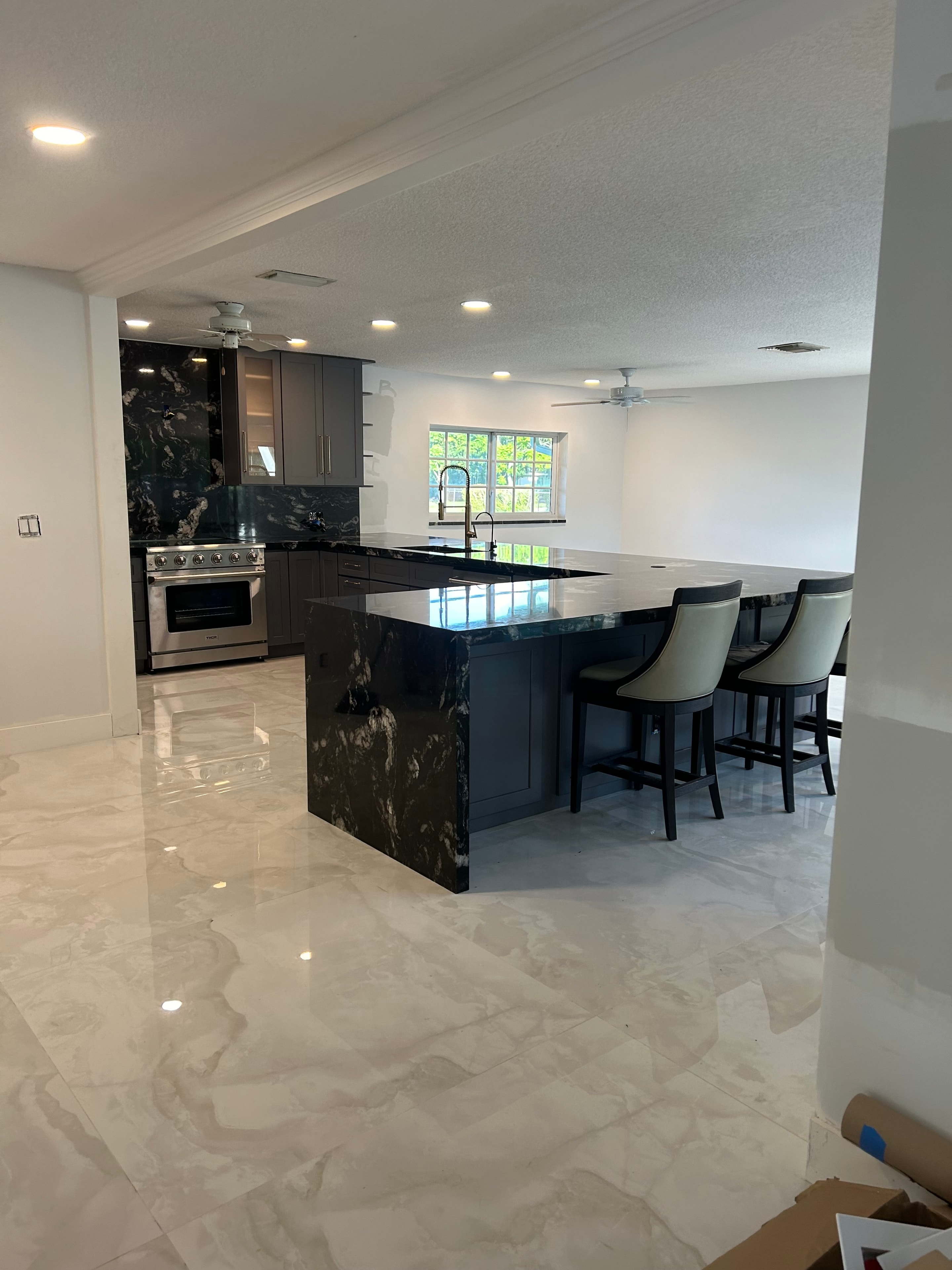 Modern kitchen remodel with black marble island — Sebring, FL