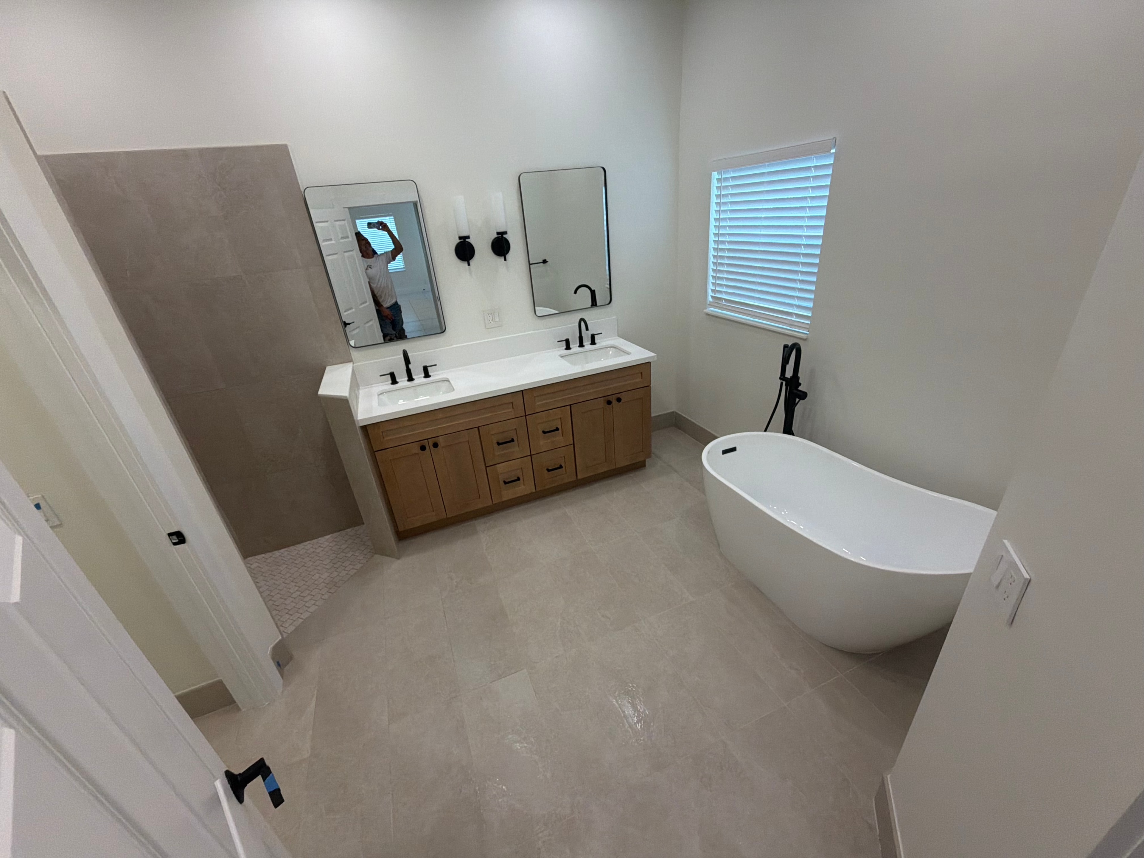 Double vanity bathroom with freestanding soaking tub — Serenity Flooring Plus