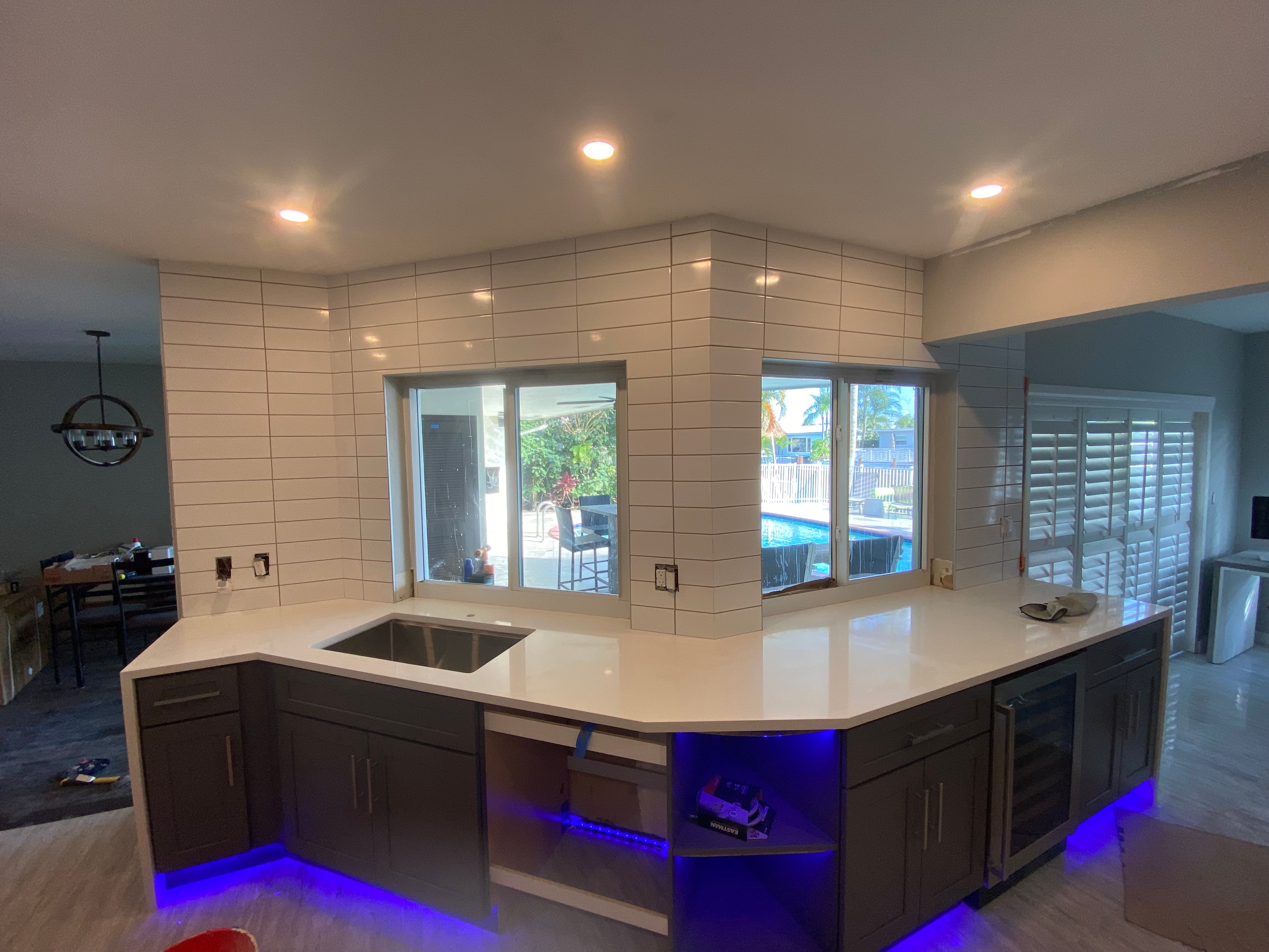 Kitchen island with blue accent lighting — Serenity Flooring Plus remodel