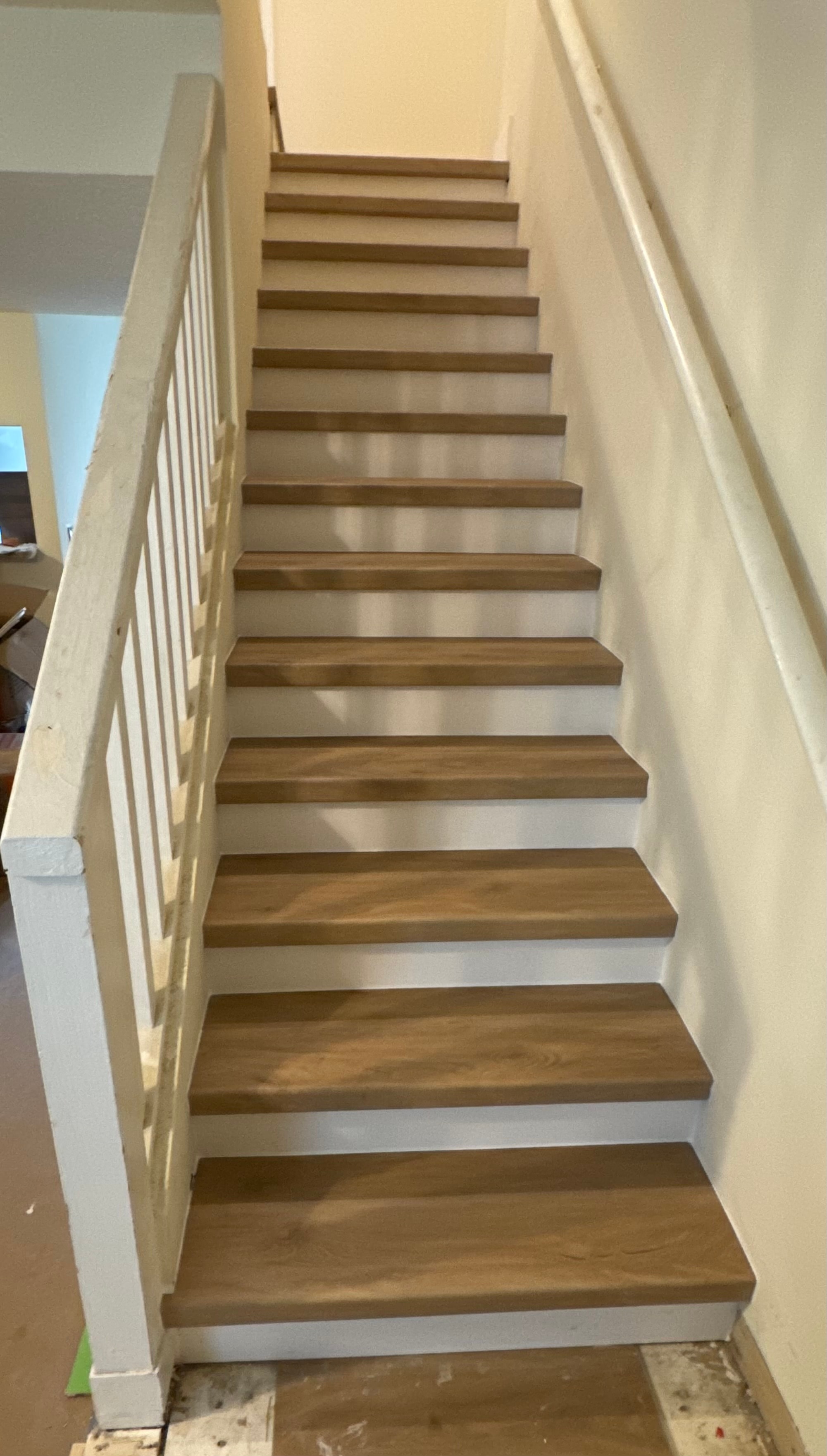 Wooden staircase with white railing — interior remodel Highlands County