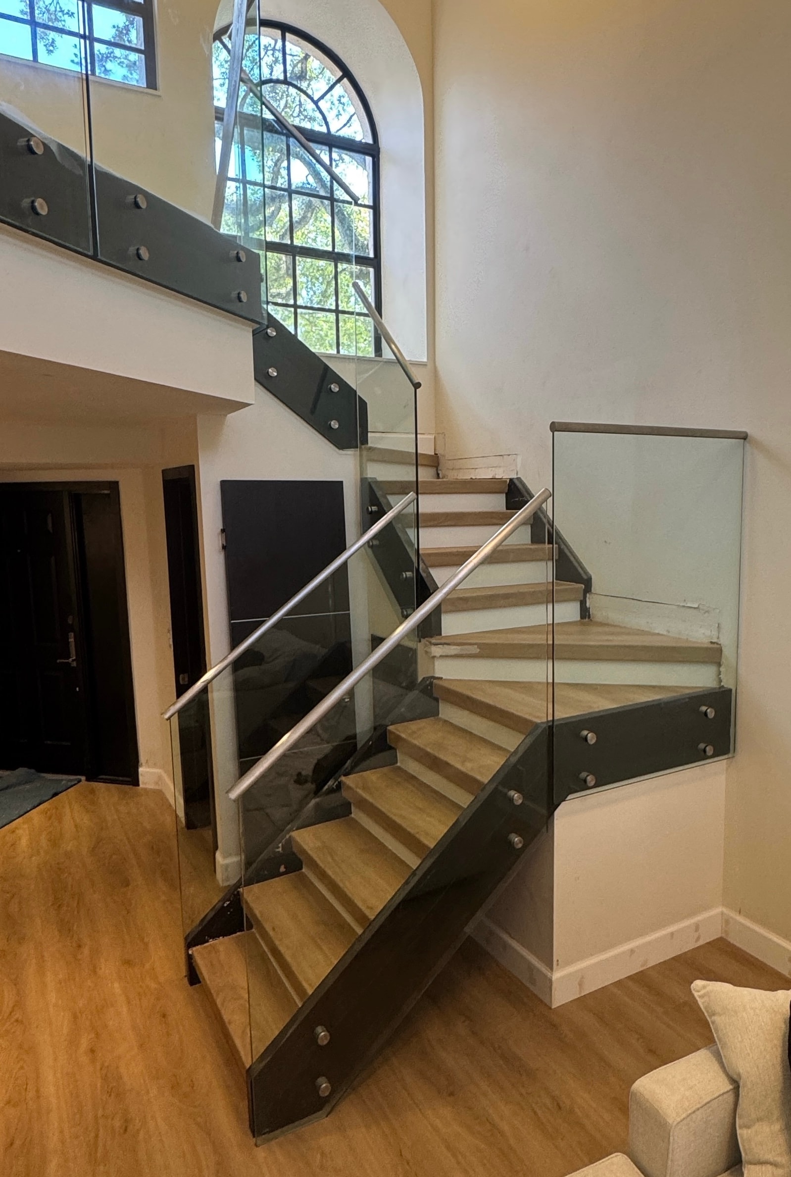 Modern staircase with glass railing and arched window — Sebring, FL