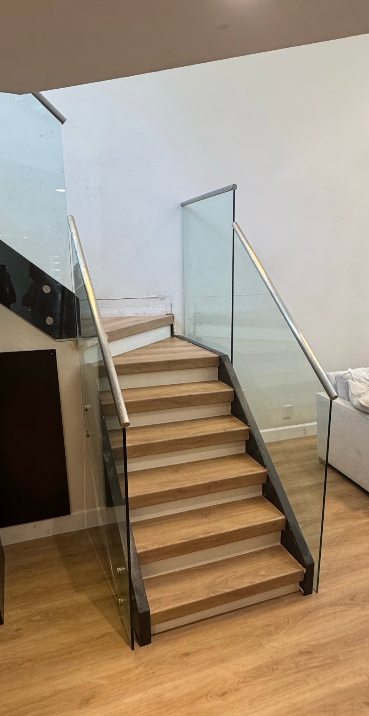 Contemporary staircase with glass railing and wood steps — Highlands County