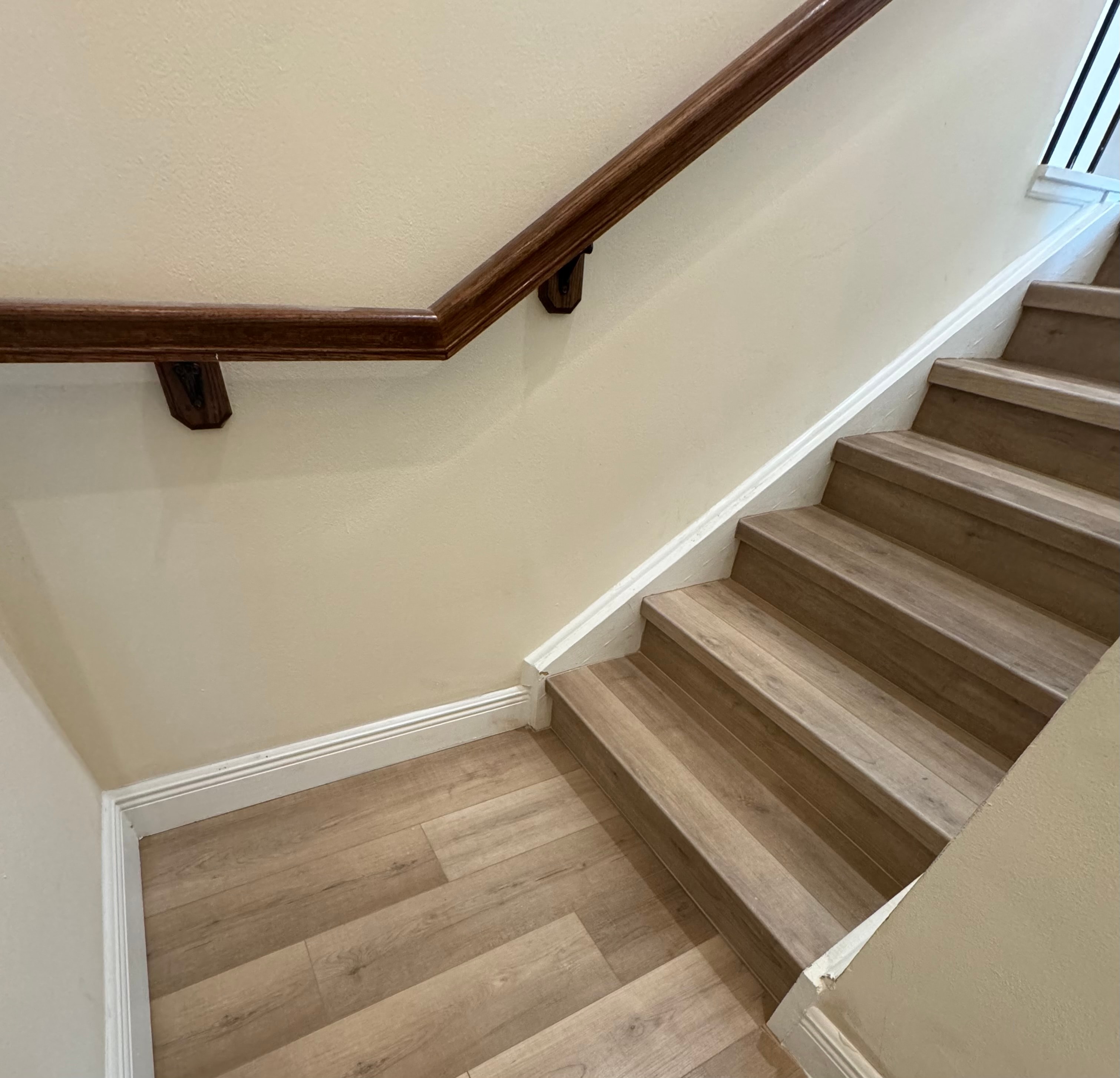 Staircase with dark wood handrail — Serenity Flooring Plus project